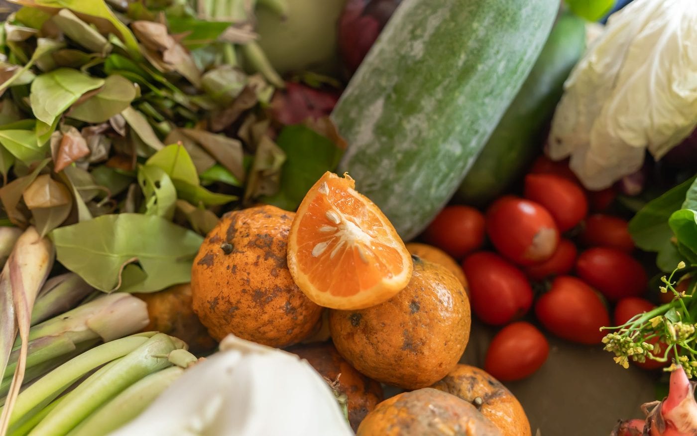 Fresh vegetables and citrus fruit on a market table