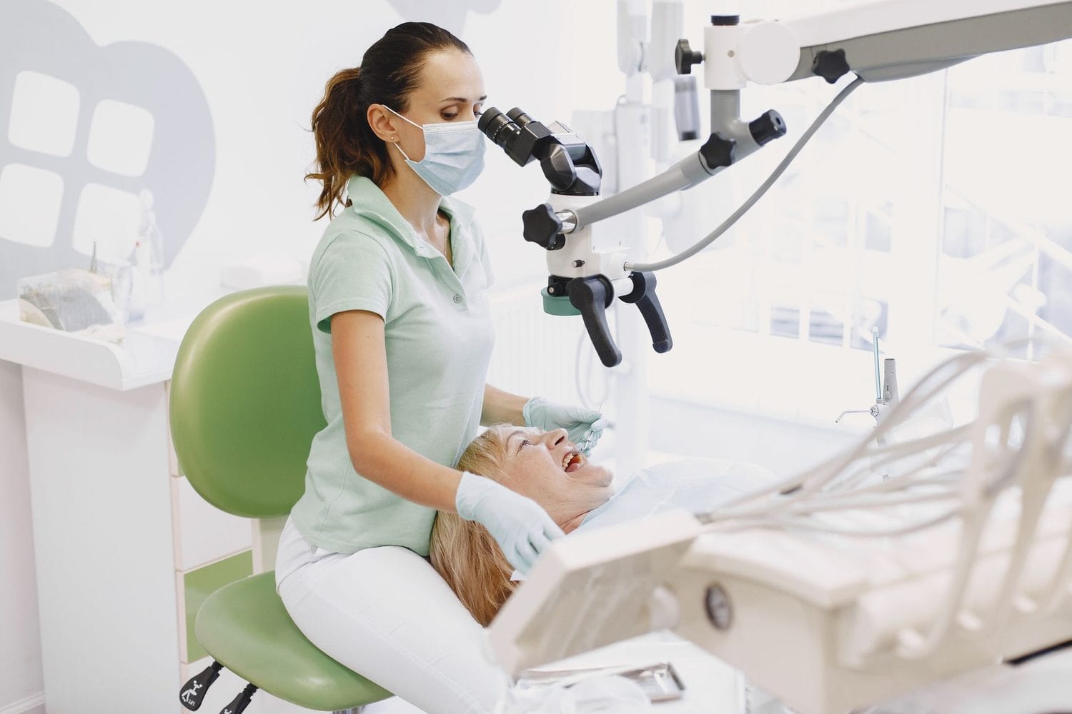 Dentist working through a dental operating microscope during a root canal